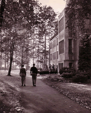 Two students walking by Science Hall, St. Mary's Convent in background, 1940