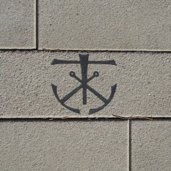 Cross and anchor symbol on Library plaza paver