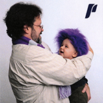 Marc Covert with his son, Ollie, wearing UP white and purple