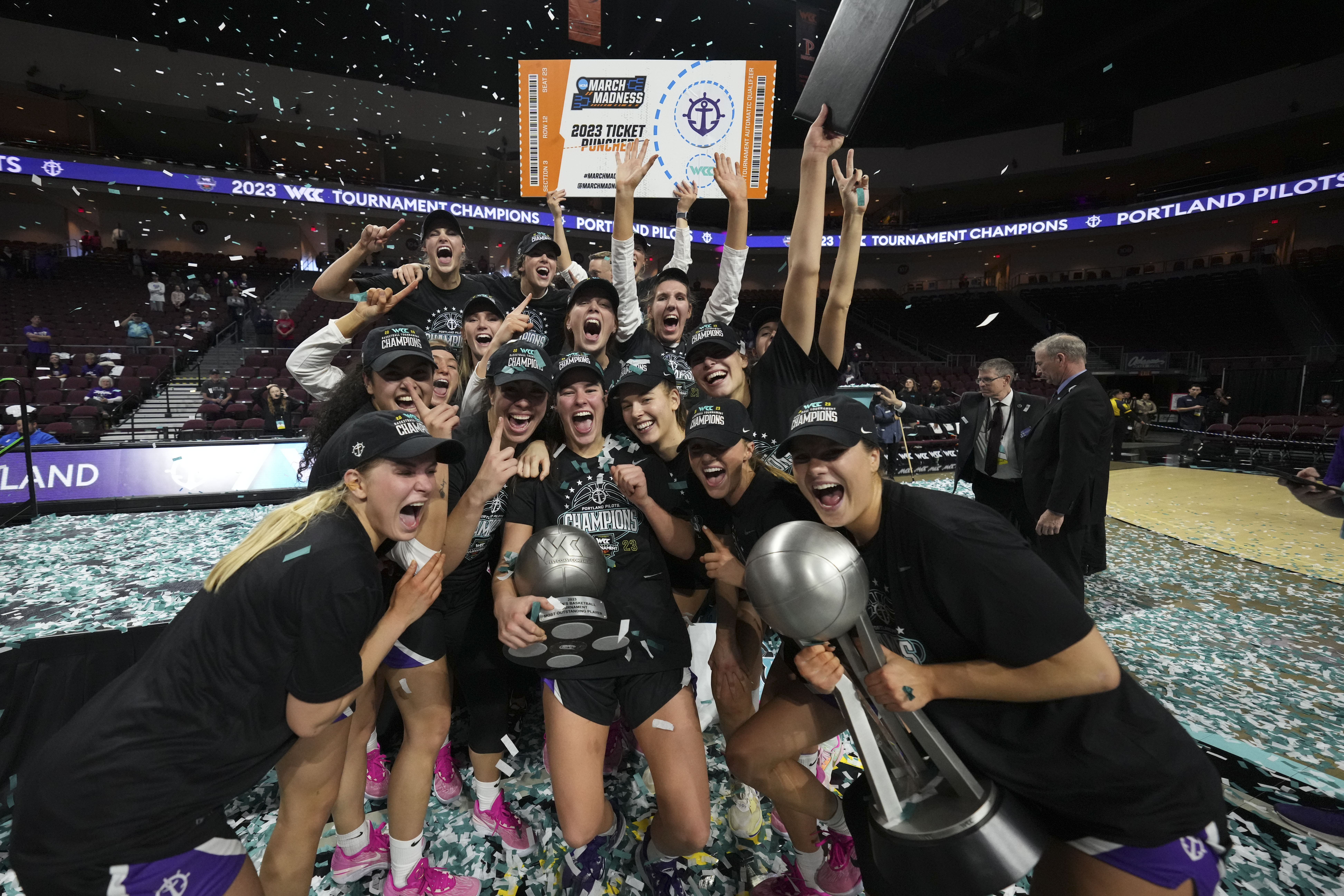 women's basketball team posing with WCC championship trophy